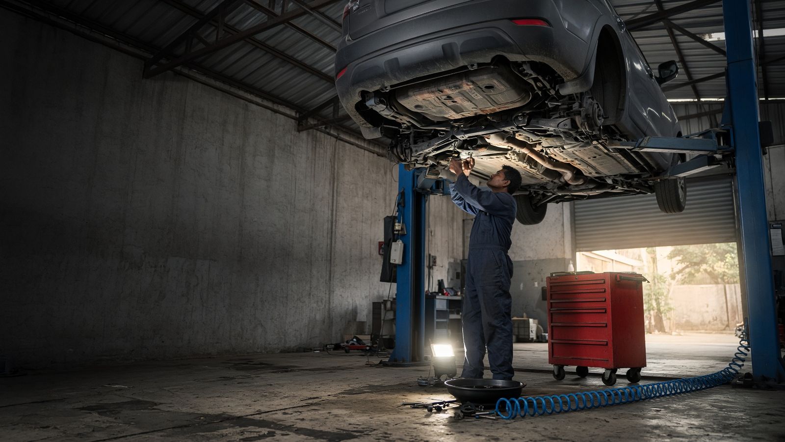 Korean vehicle repair workshop - Korean SUV on hydraulic lift for suspension and brake service